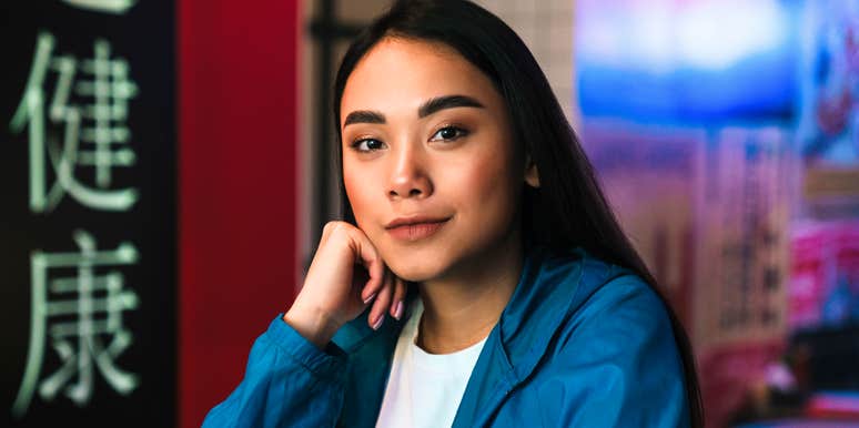 Thoughtful person sitting alone in a busy café, realizing insights about people that suddenly make everything feel less personal.