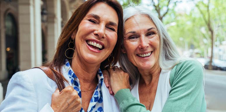 two friends from the 1970s hugging each other