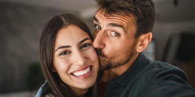 happy couple with husband kissing wife's cheek