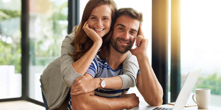man with boring traits hugged by wife smiling