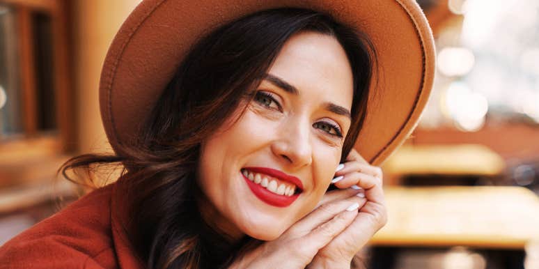 Woman smiling with calm self-assurance, reflecting the quiet boundaries and self-focused habits that keep burnout away.