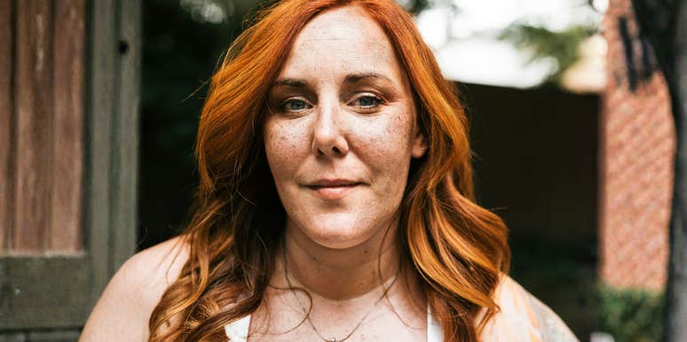 Woman with a calm, steady expression standing outdoors, capturing the quiet strength of people who don’t let a breakup completely derail them