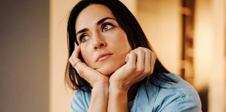 adult sitting in quiet reflection with a distant, heavy expression, capturing the core emotional indicator psychologists say points to childhood emotional neglect