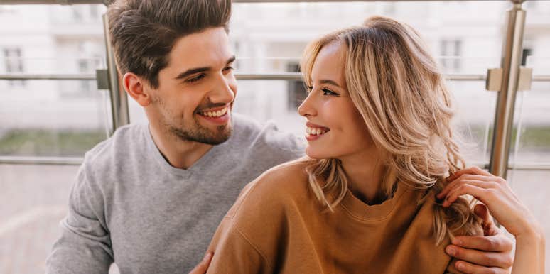 affectionate husband holding happy wife