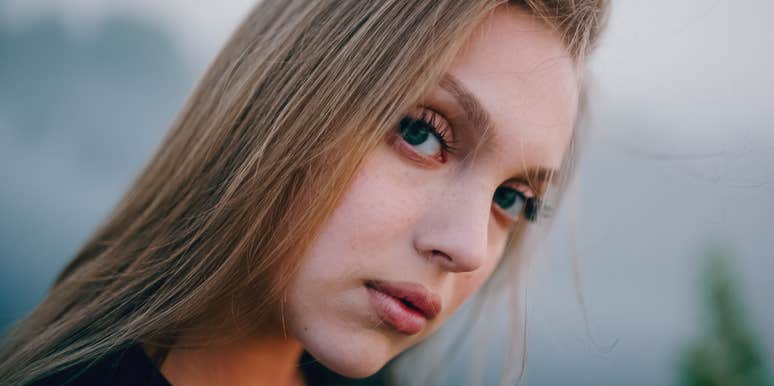 serious woman with a hidden cruel streak thinking