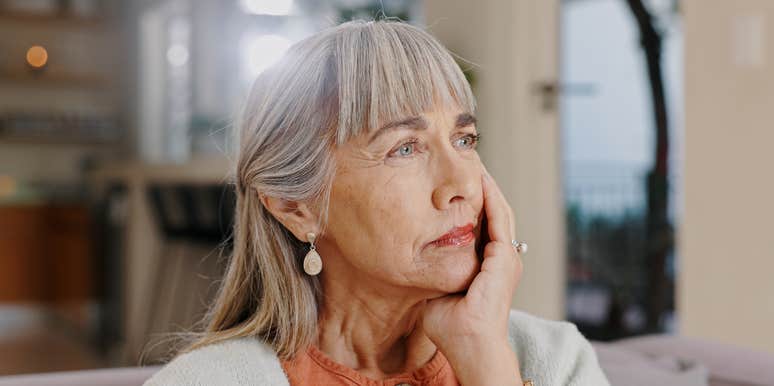 thoughtful woman sitting on couch