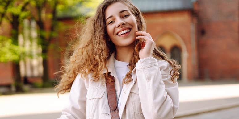 young woman touching her hair outside