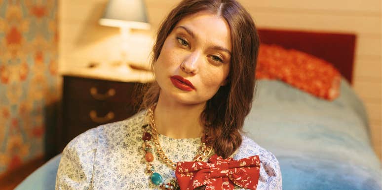 beautiful woman with a conflicted thoughtful expression, illustrating the hidden complications and quiet costs that often come with being seen as ‘pretty’