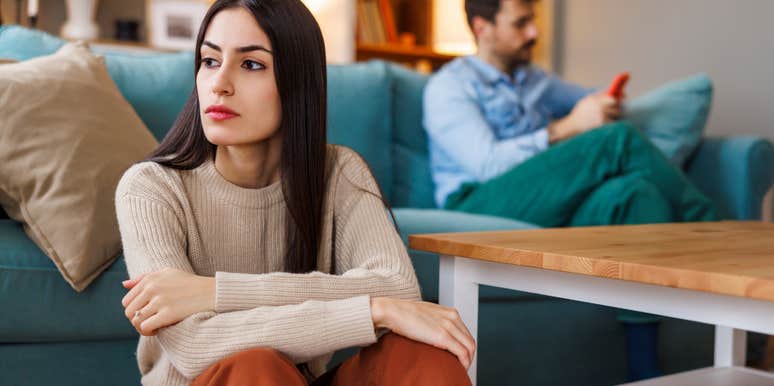 sad woman who is done trying in her marriage sitting in living room