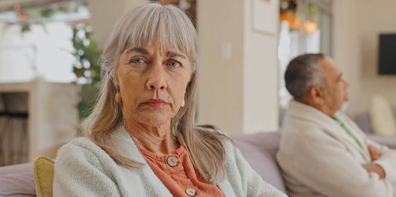 wife sitting on edge of couch away from husband after fight