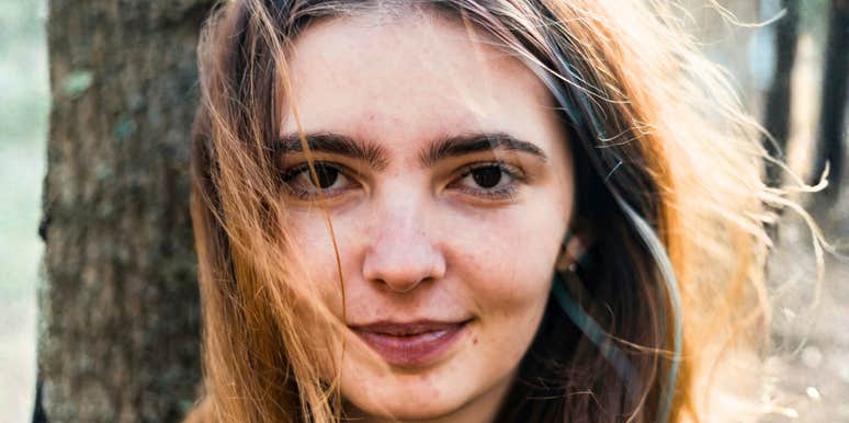 Natural light portrait of a woman outdoors with a neutral expression