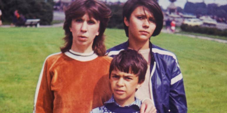 Vintage photo of children standing together in a grassy park.