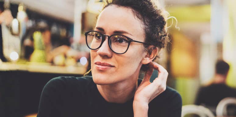 Woman sitting thoughtfully, reflecting on unresolved emotions that come from being with a partner who hasn’t fully matured
