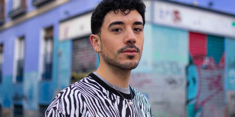 serious man standing outside looking at camera