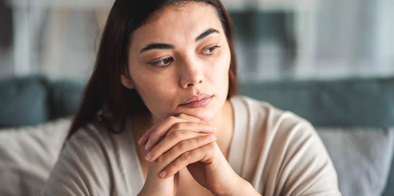 woman feeling overwhelmed by life sitting at home