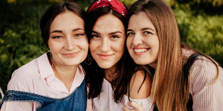 Three close friends sit together outdoors, reflecting the quiet questions that reveal which friendships last and which simply fill space.