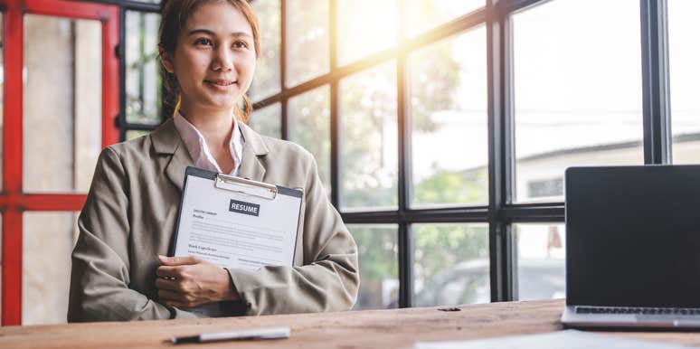 woman holding resume applying for job
