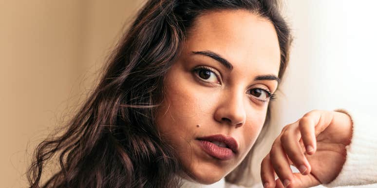 Thoughtful woman looking toward the camera in soft natural light