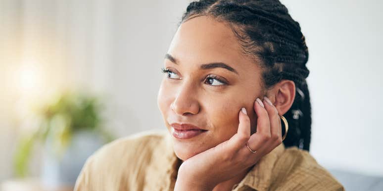 woman thinking with hand on her face