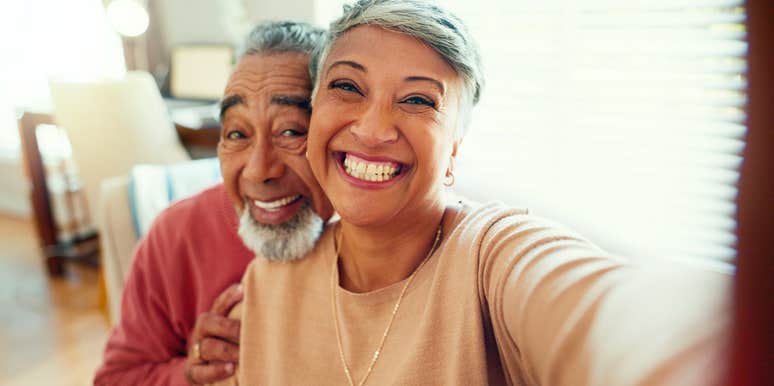 wife taking selfie of her and husband smiling happily