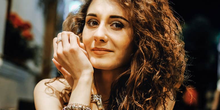 Close-up portrait of a person with curly hair indoors