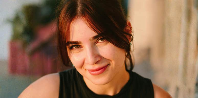 Woman looking at the camera outdoors.