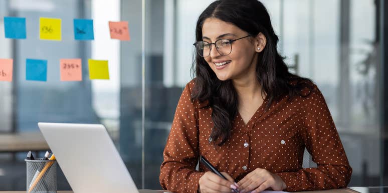 woman who is happy at work because she's been given unlimited sick days