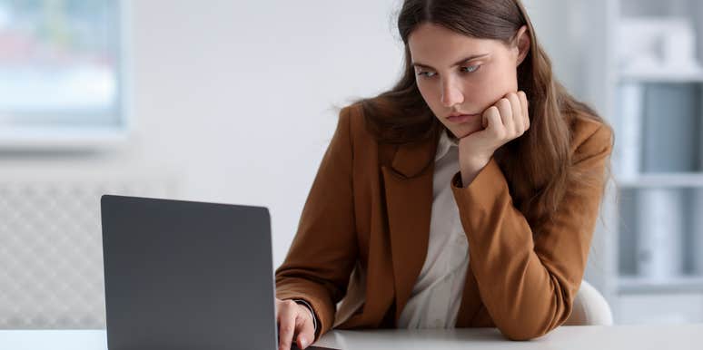 young woman working on laptop at table