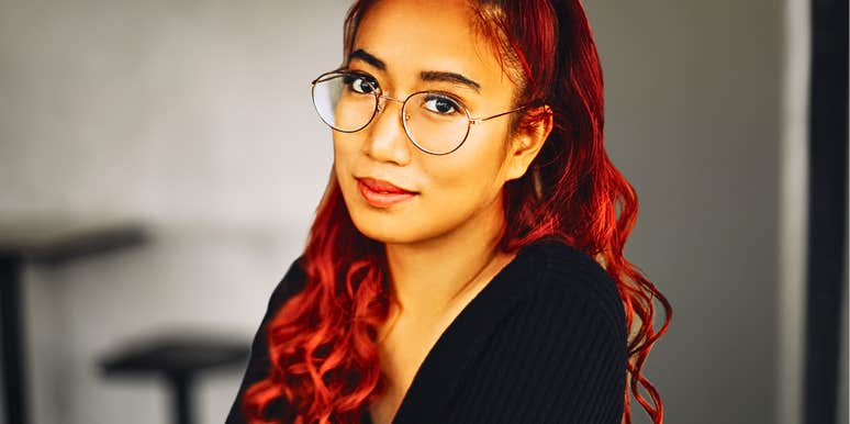 Genuinely brilliant woman looks wisely at camera