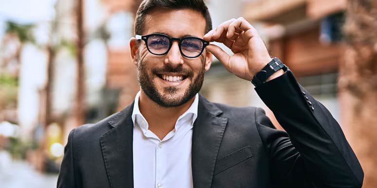 A man with true emotional intelligence adjusting his glasses