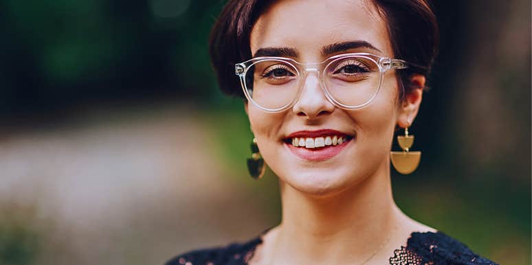 Confident young woman with old-fashioned values glasses outdoors