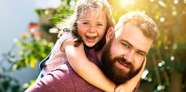 Father and daughter together playing outside together. 