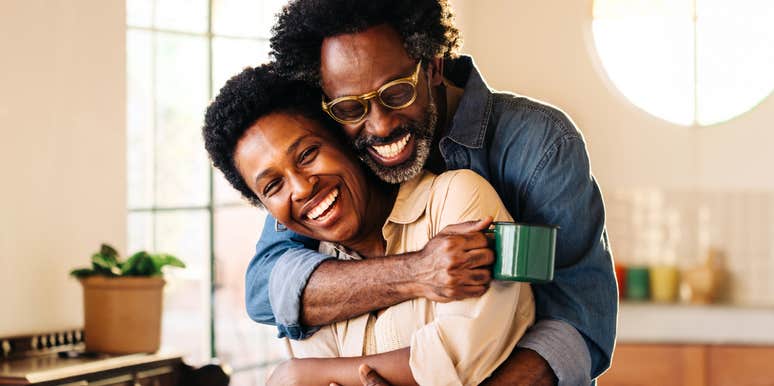 happy couple embracing in a bright kitchen