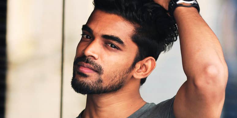 Man running hands through his hair, showing stress or frustration, highlighting signs that his ex may still influence him