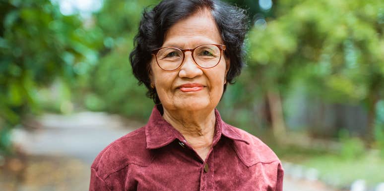 older woman smiling outside saying outdated phrases