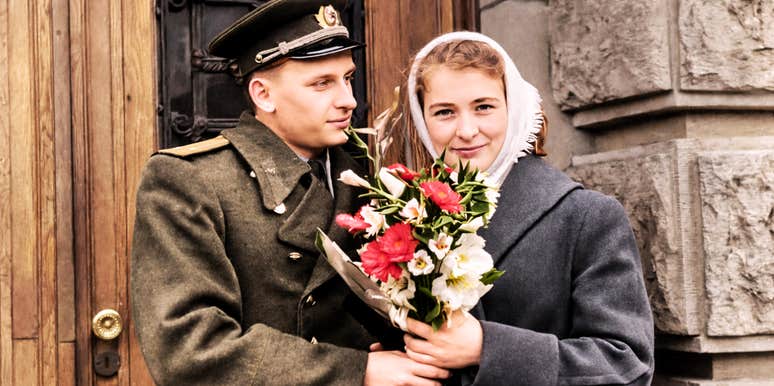 vintage photo of man giving woman flowers.