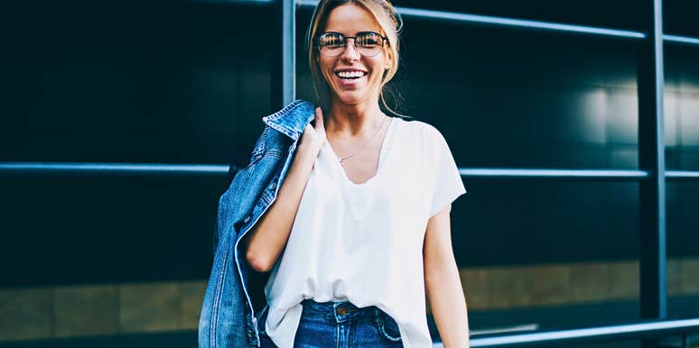 Woman who isn't afraid of artifical intelligence stands confidently outside work