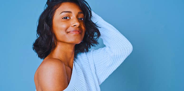 Woman who follows ancient body oiling tradition smiling and glowing