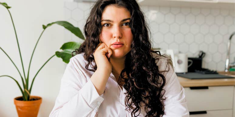 anxious woman sitting at the table shaking her leg
