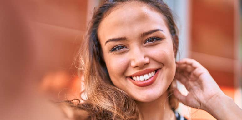 beautiful woman taking a selfie outside