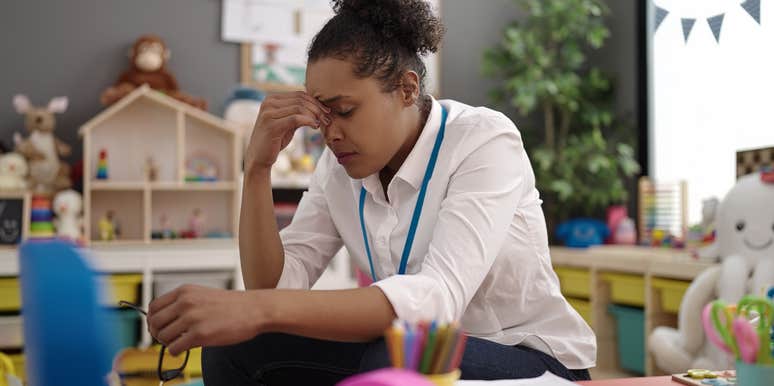 stressed teacher sitting in classroom