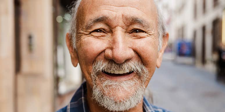 A smiling older man confidently handling a task, illustrating the traditional work ethic and self-reliance that defined older generations.