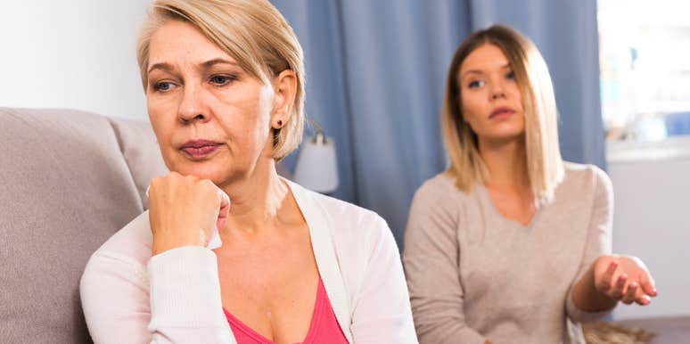 sad older woman turned away from her adult daughter