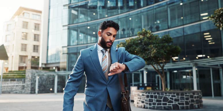 businessman running late to work checking watch