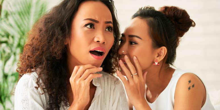 Friend telling a shocking secret to another woman, capturing the high-stakes emotional triggers and early marriage challenges discussed by relationship experts.