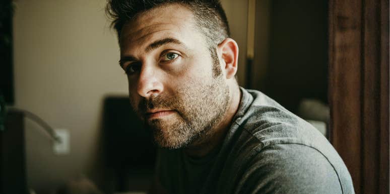 A man with a beard looking distant and lost, illustrating the 'flat affect' and signs of high-functioning depression that go beyond temporary sadness.