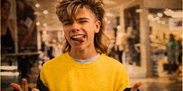 A vintage 1980s photo of a teenager at a mall sticking out her tongue and winking, illustrating the 'Gen-X attitude' and the rebellious spirit of Eighties youth culture.