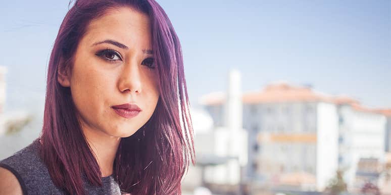 Young woman who isn't a good friend looks sharply at the camera