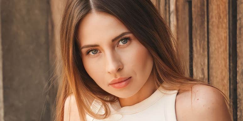 A woman with a serious, guarded expression, representing the long-term psychological impact of growing up in an emotionally distant household.