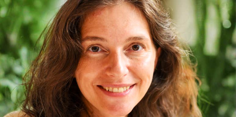 A mature woman with a natural, unadorned face and a serene expression, representing a happy woman